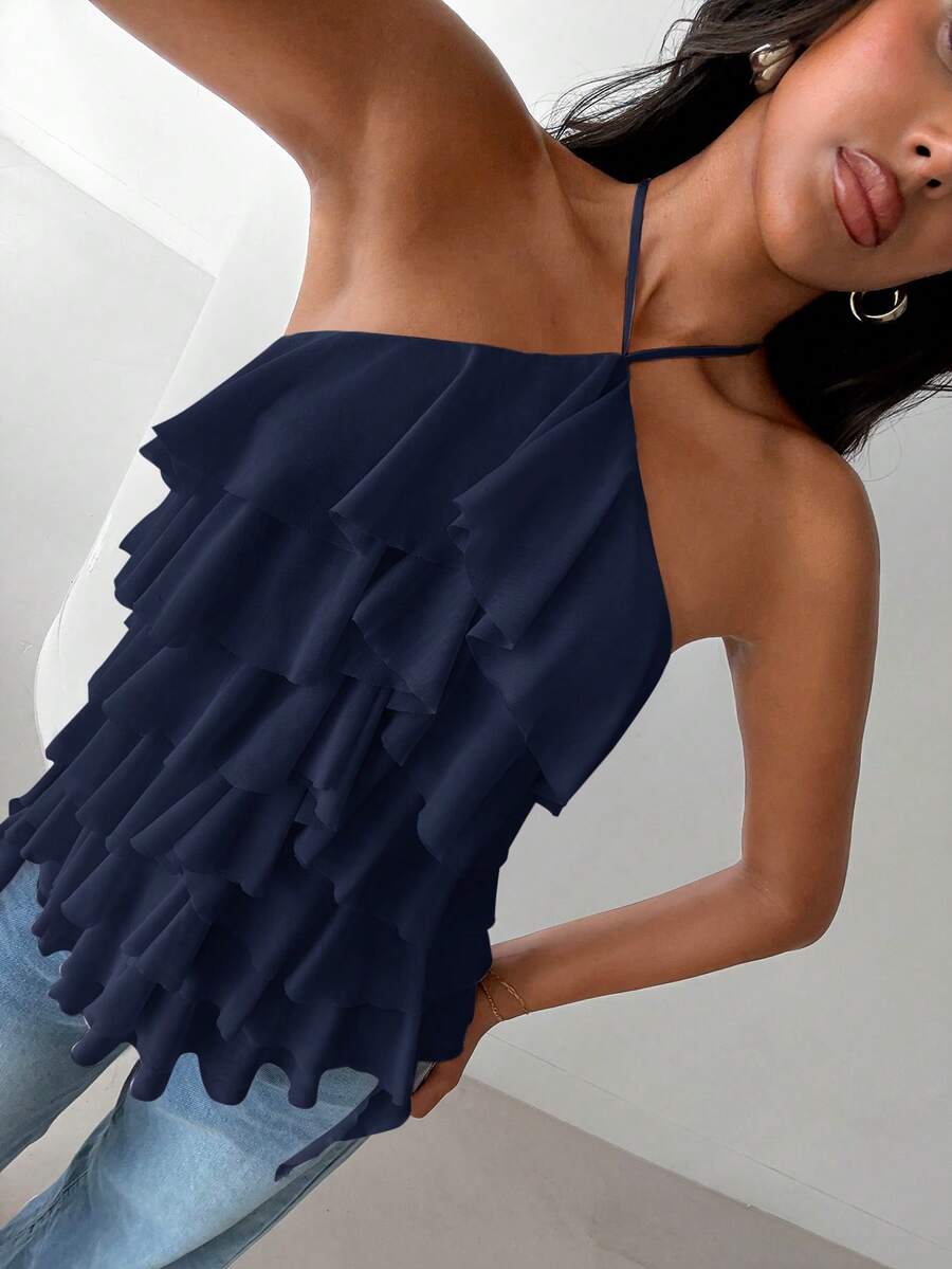 Women's sleeveless halter neck top featuring tiered ruffle layers, a backless cut, and an asymmetrical hem.