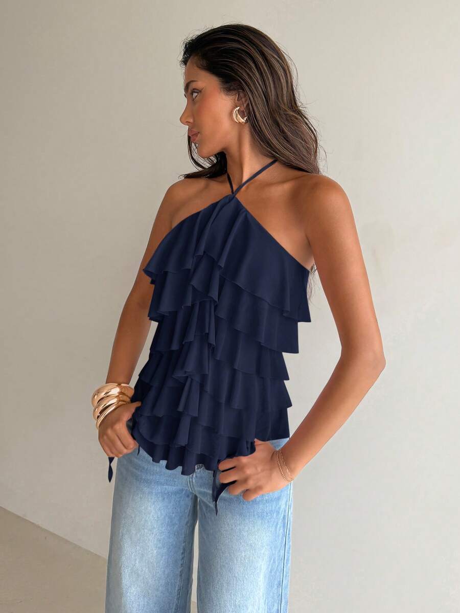 Women's sleeveless halter neck top featuring tiered ruffle layers, a backless cut, and an asymmetrical hem.