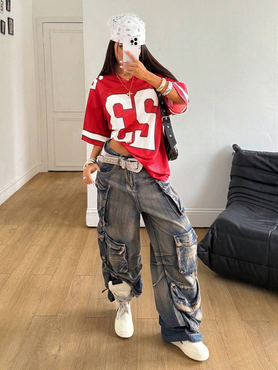 Oversized short-sleeve football jersey top featuring a V-neckline, contrast binding, and graphic number print.