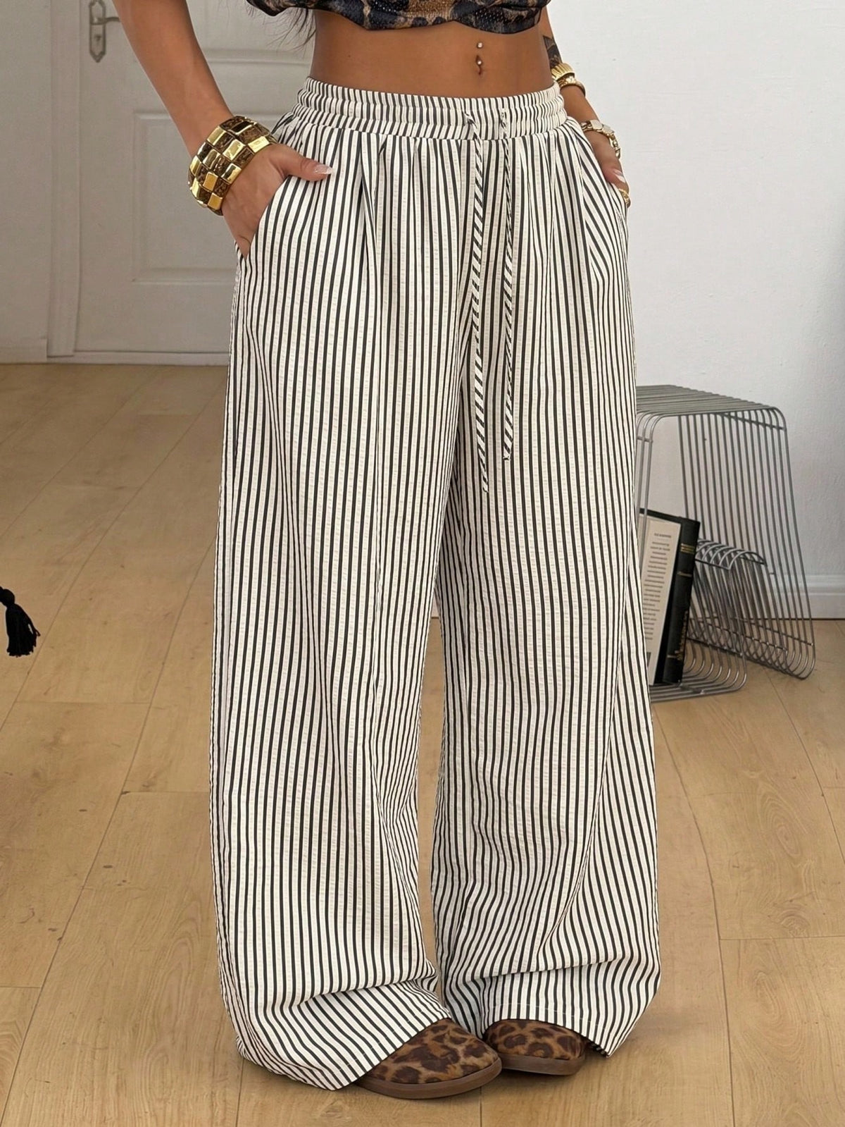 Plus size women's striped loose straight leg cropped pants with pleated detailing and side pockets