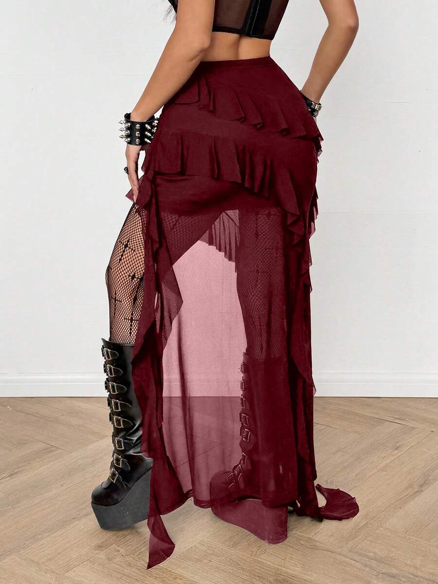Women's low rise asymmetrical long skirt with ruffle hem detailing in semi-sheer knitted fabric.