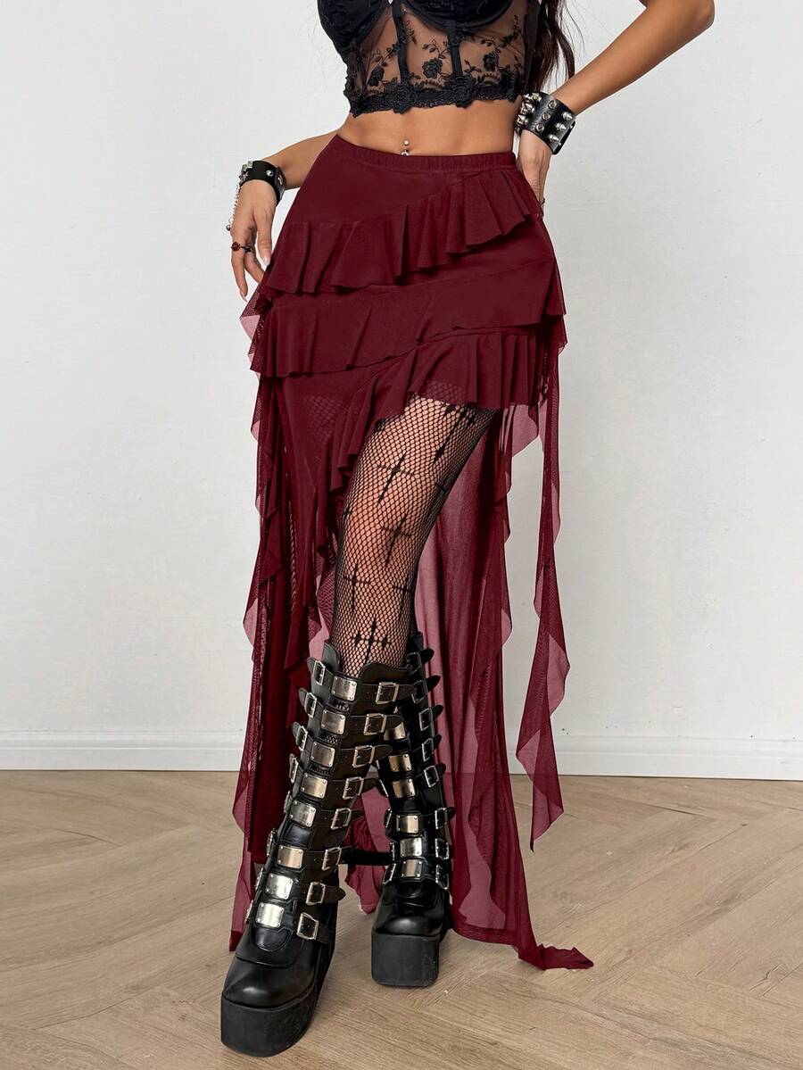 Women's low rise asymmetrical long skirt with ruffle hem detailing in semi-sheer knitted fabric.