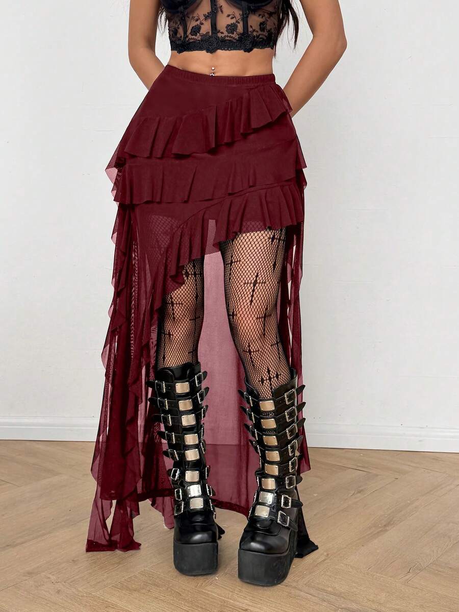 Women's low rise asymmetrical long skirt with ruffle hem detailing in semi-sheer knitted fabric.