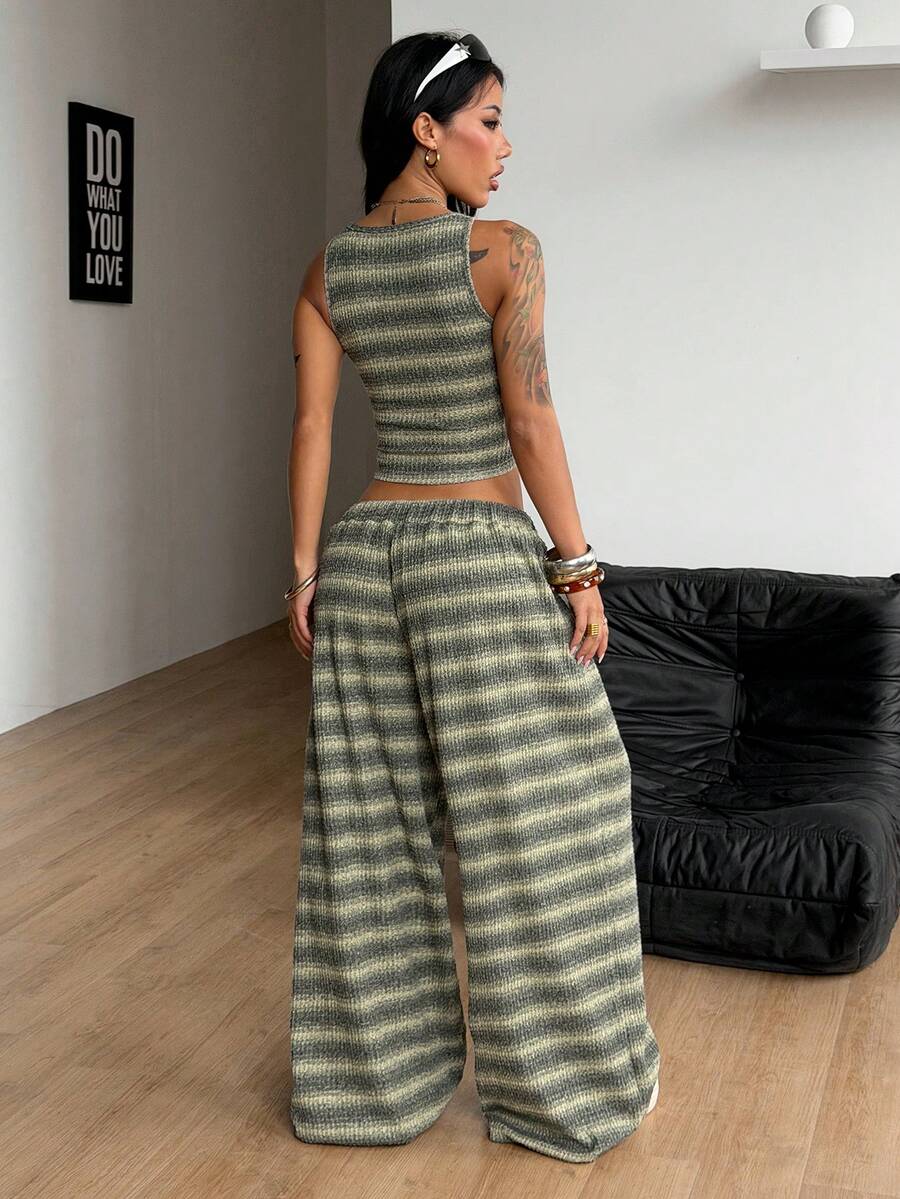 Women's two-piece casual outfit featuring a slim-fit camisole tank top with ruffle trim and button front paired with high-waisted wide leg pants.