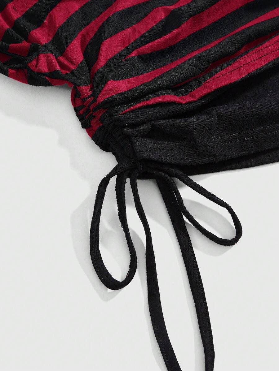 Women's striped t-shirt featuring an asymmetric cold shoulder neckline, batwing short sleeves, and ruched drawstring details in a loose knit fit.