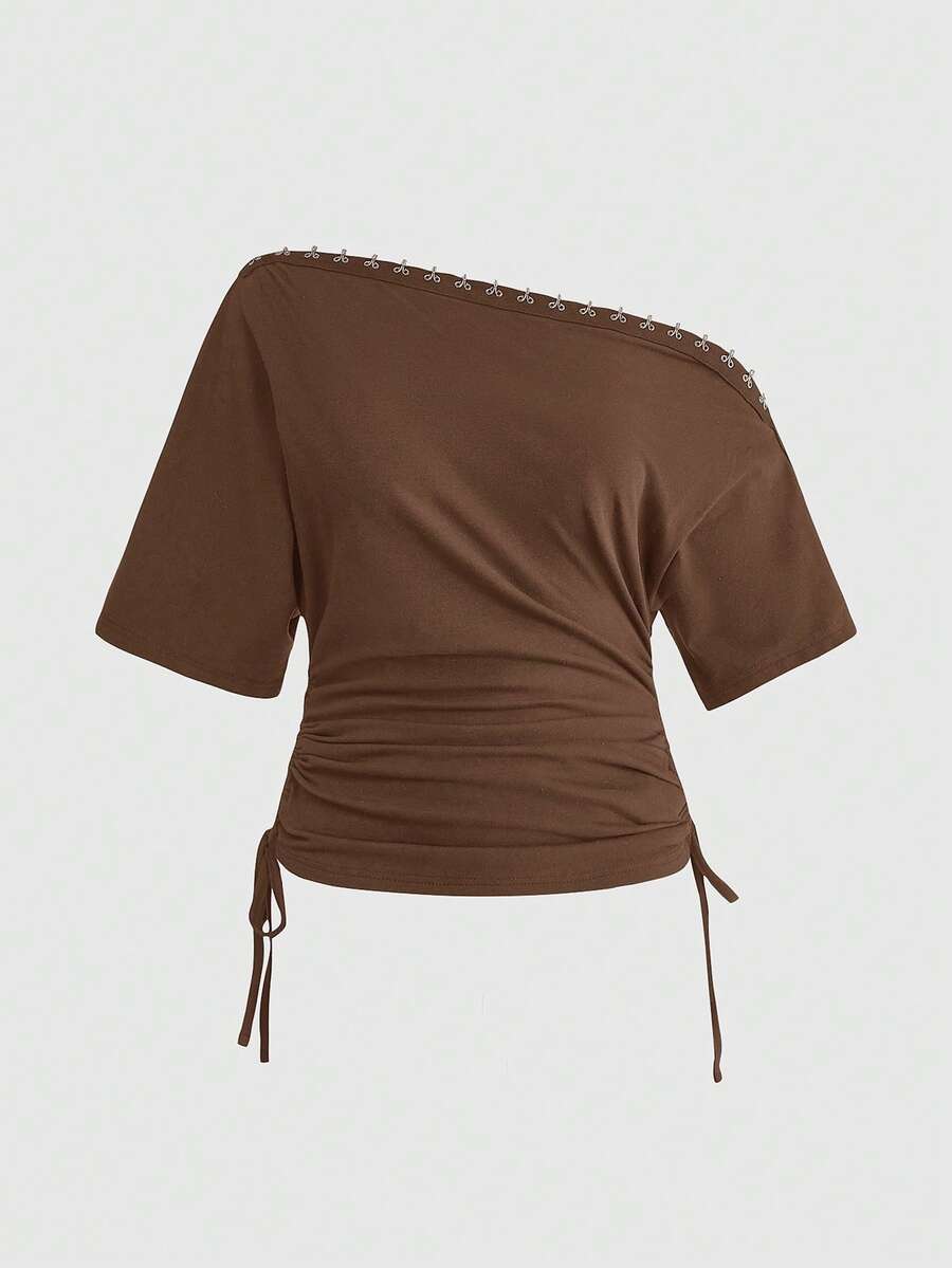 Women's slim fit short sleeve t-shirt featuring an asymmetric off-the-shoulder neckline, ruched design, and metal buckle detail.