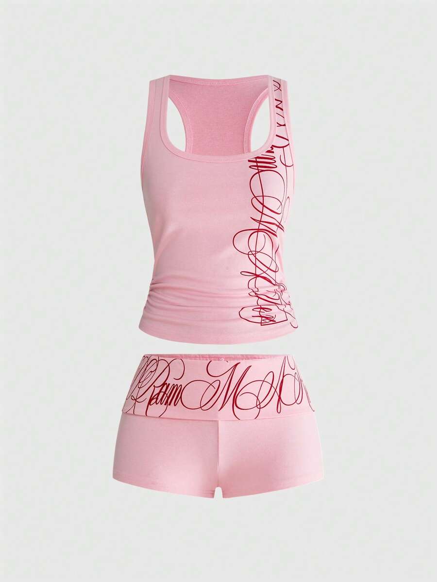 Punk-inspired two-piece set with a fitted scoop neck slogan tank top featuring cross and rhinestone details paired with ultra low waist mini shorts.