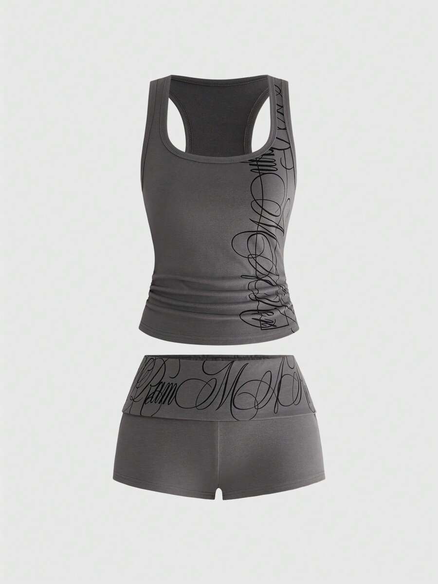 Punk-inspired two-piece set with a fitted scoop neck slogan tank top featuring cross and rhinestone details paired with ultra low waist mini shorts.