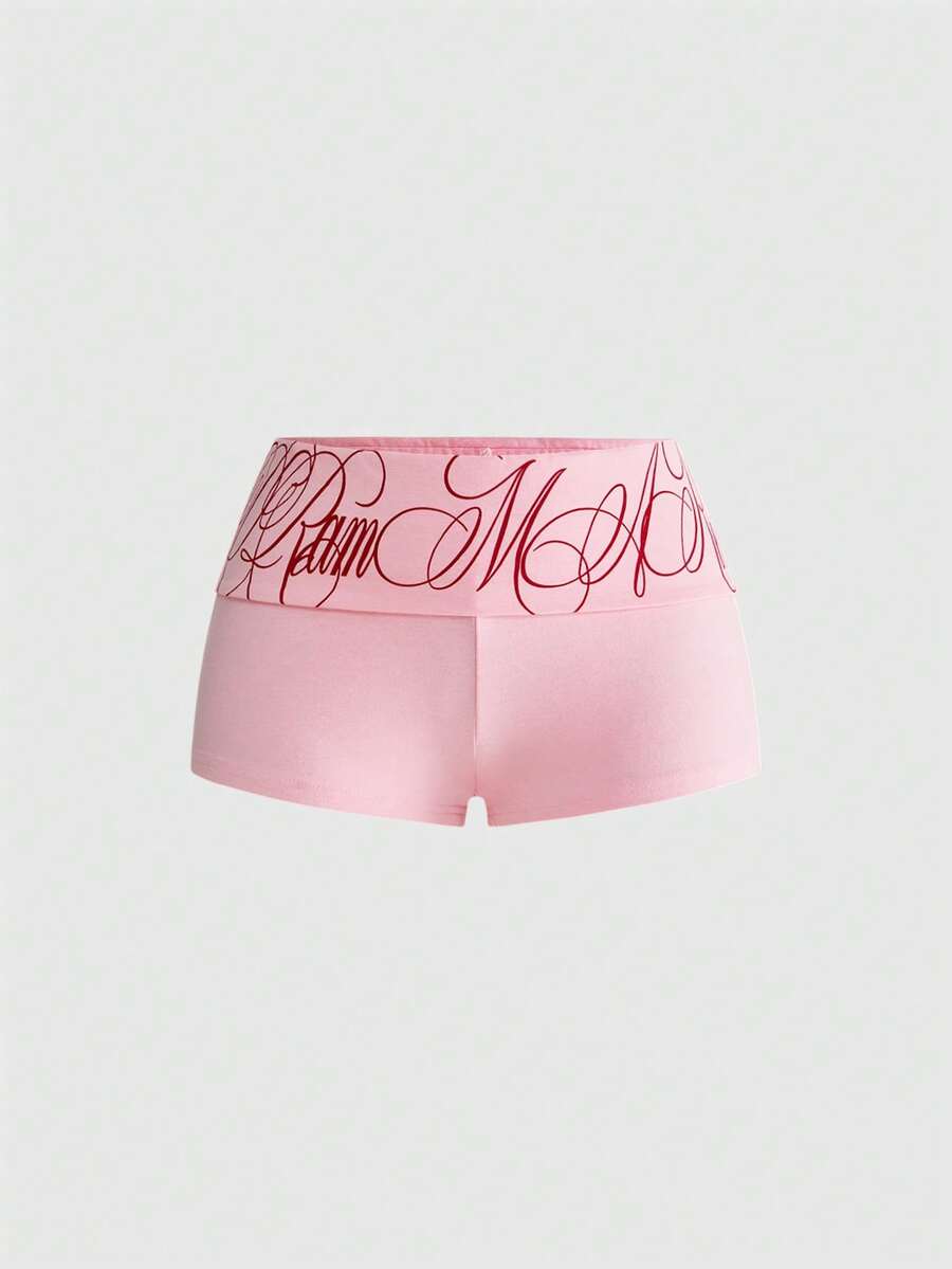 Punk-inspired two-piece set with a fitted scoop neck slogan tank top featuring cross and rhinestone details paired with ultra low waist mini shorts.