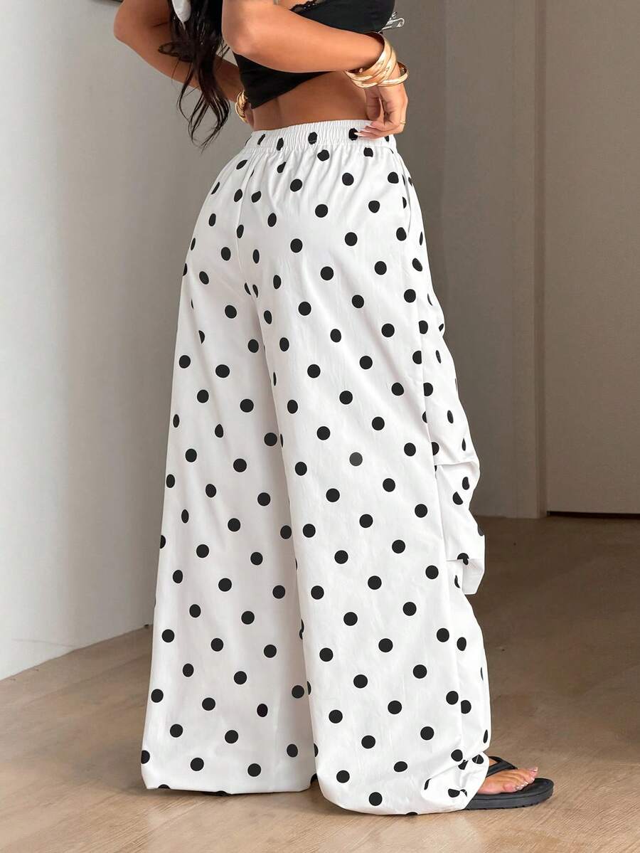 Women's black and white striped wide leg pants featuring an elastic drawstring waistband, side pockets, and a loose straight leg fit.