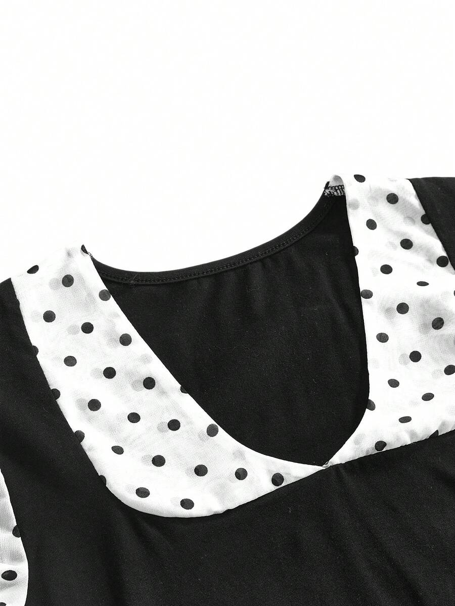 Women's black short puff sleeve graphic print t-shirt featuring a sweetheart neckline and knot detail.