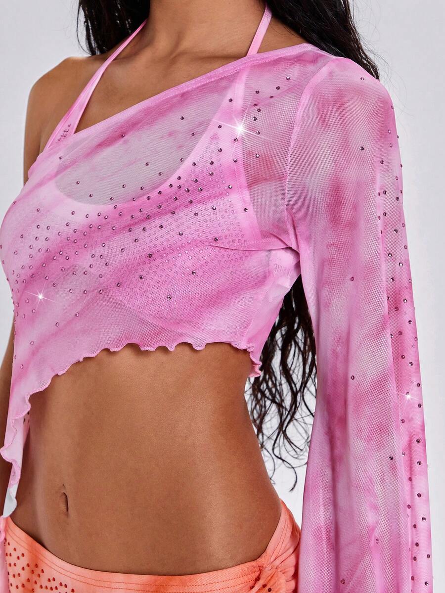 Women's one shoulder crop top featuring an asymmetrical long sleeve, colorful print, and sparkling rhinestone embellishments.