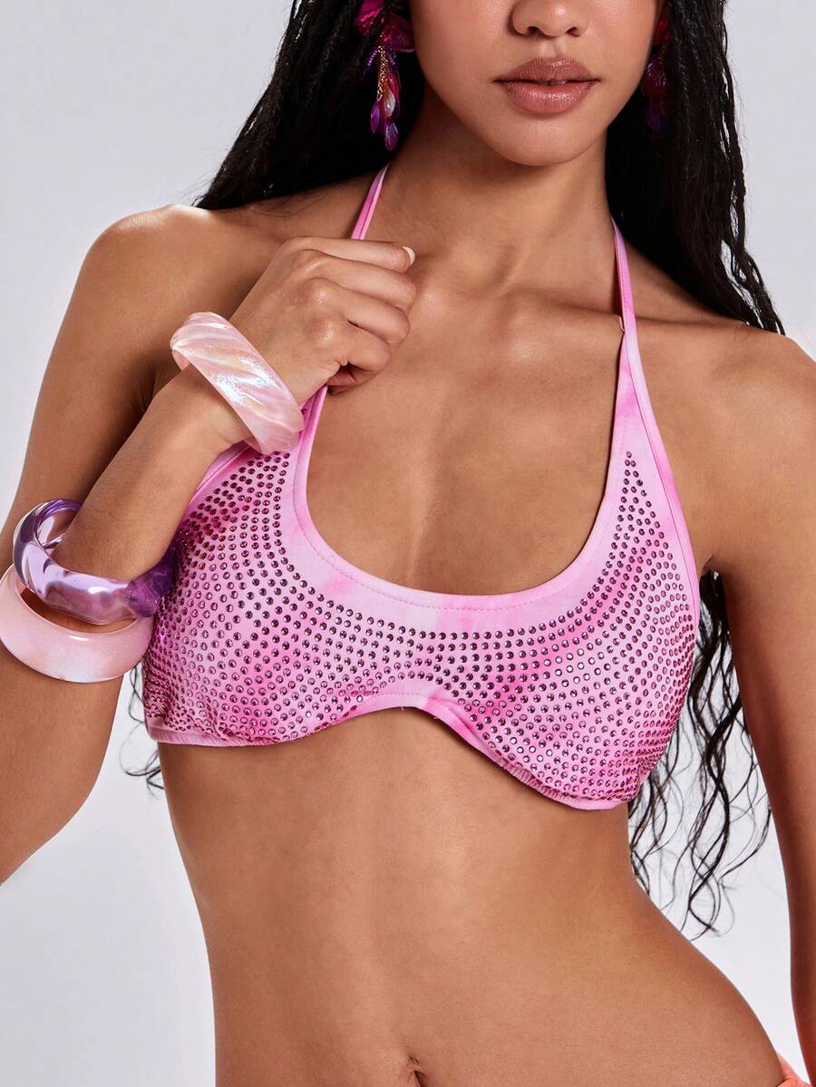 Women's one shoulder crop top featuring an asymmetrical long sleeve, colorful print, and sparkling rhinestone embellishments.
