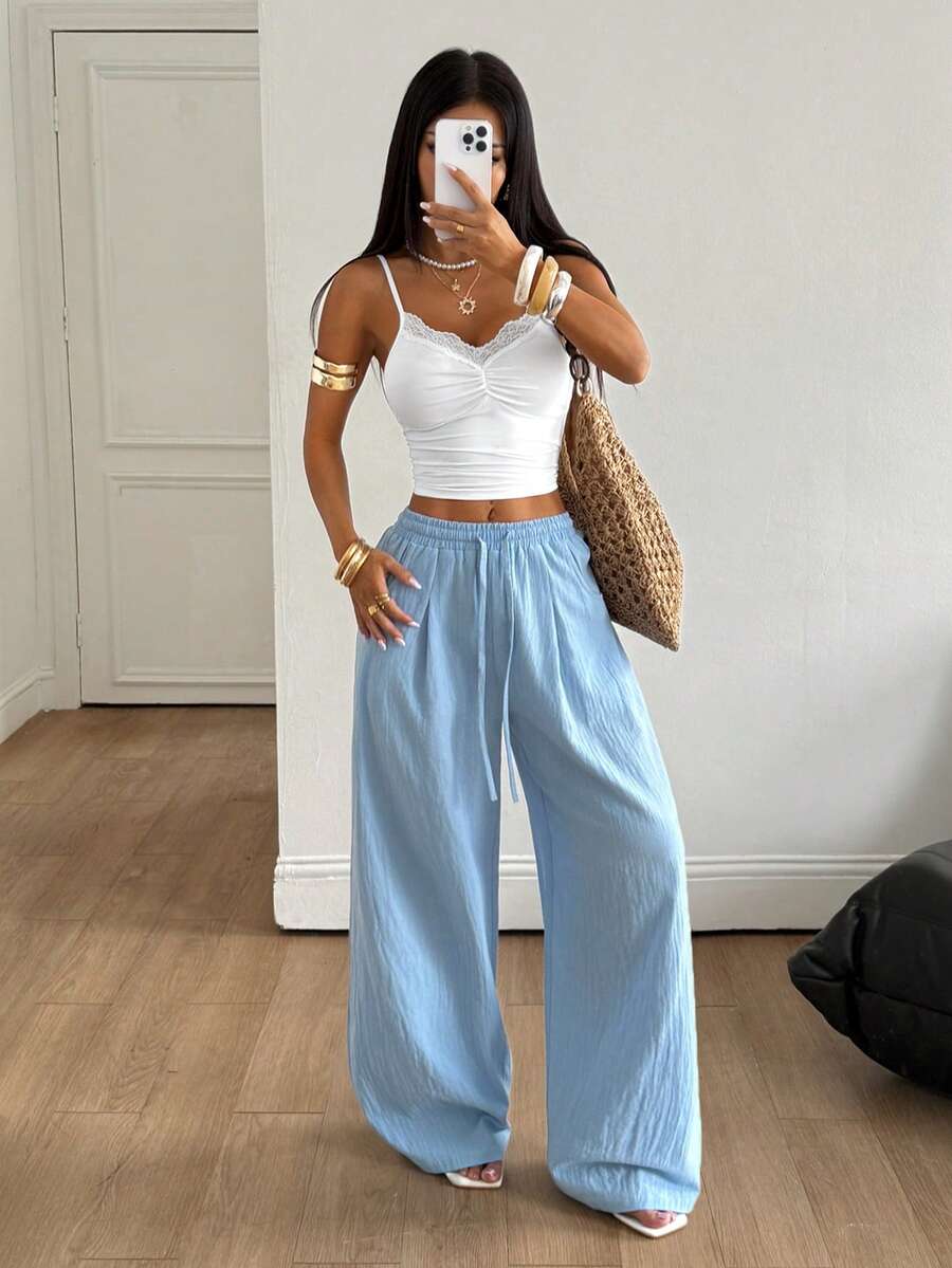 Baby blue women's wide leg baggy pants made of 100% cotton woven fabric with an elastic drawstring waist and side pockets