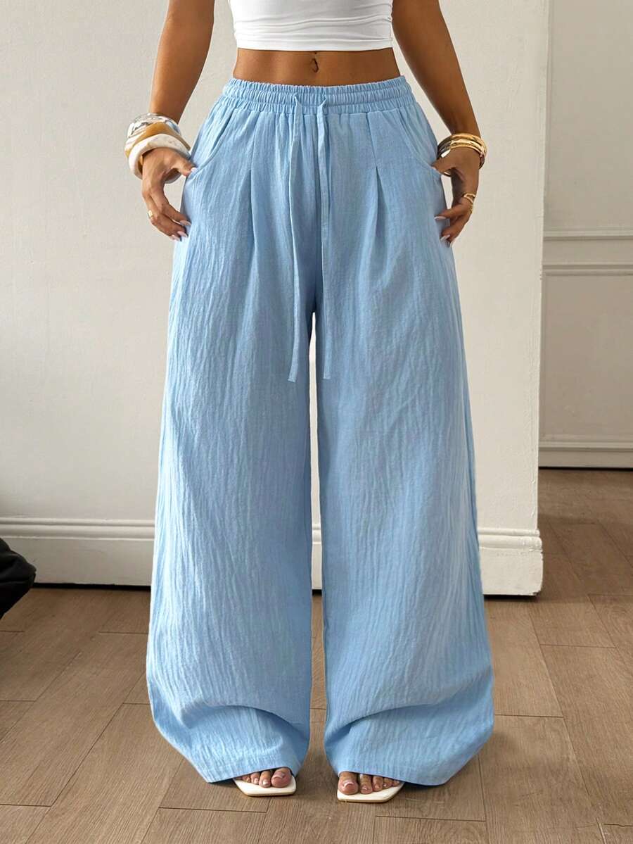 Baby blue women's wide leg baggy pants made of 100% cotton woven fabric with an elastic drawstring waist and side pockets