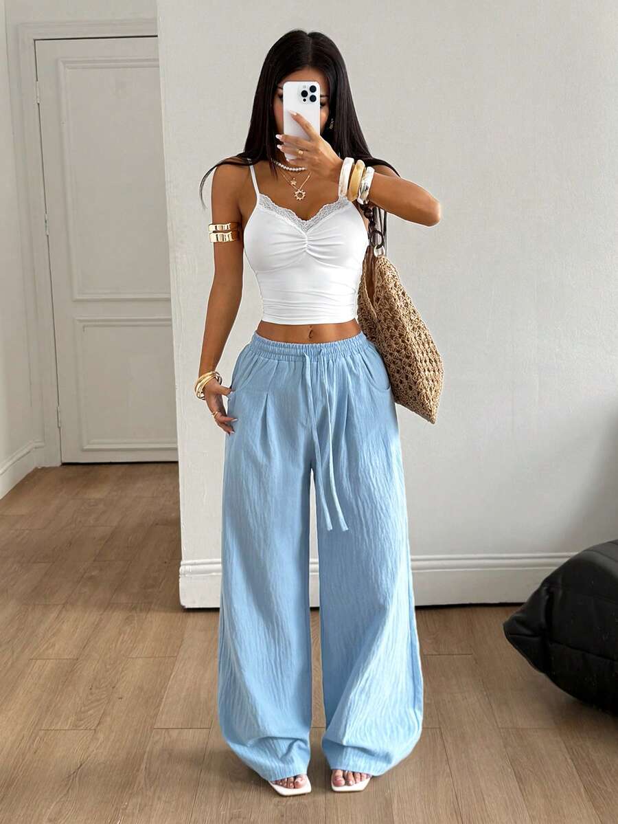 Baby blue women's wide leg baggy pants made of 100% cotton woven fabric with an elastic drawstring waist and side pockets