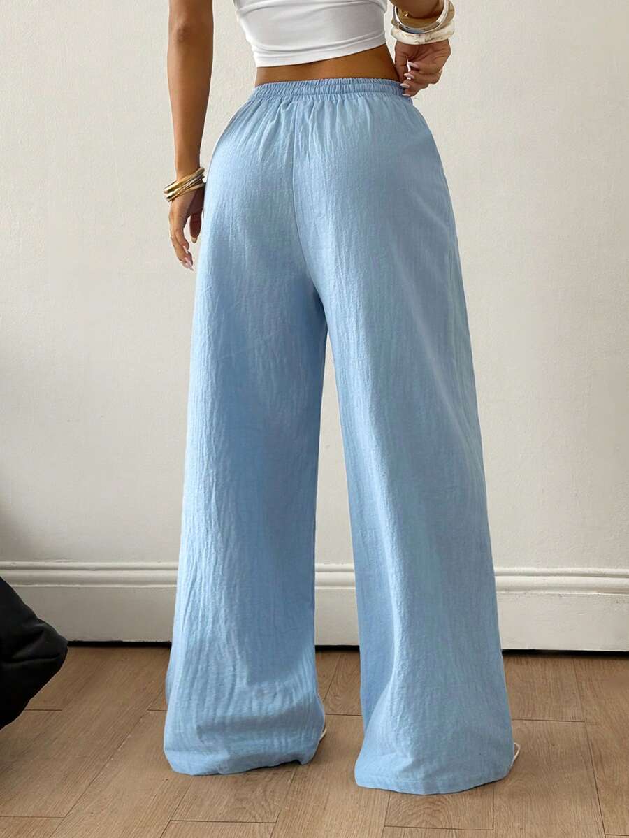 Baby blue women's wide leg baggy pants made of 100% cotton woven fabric with an elastic drawstring waist and side pockets