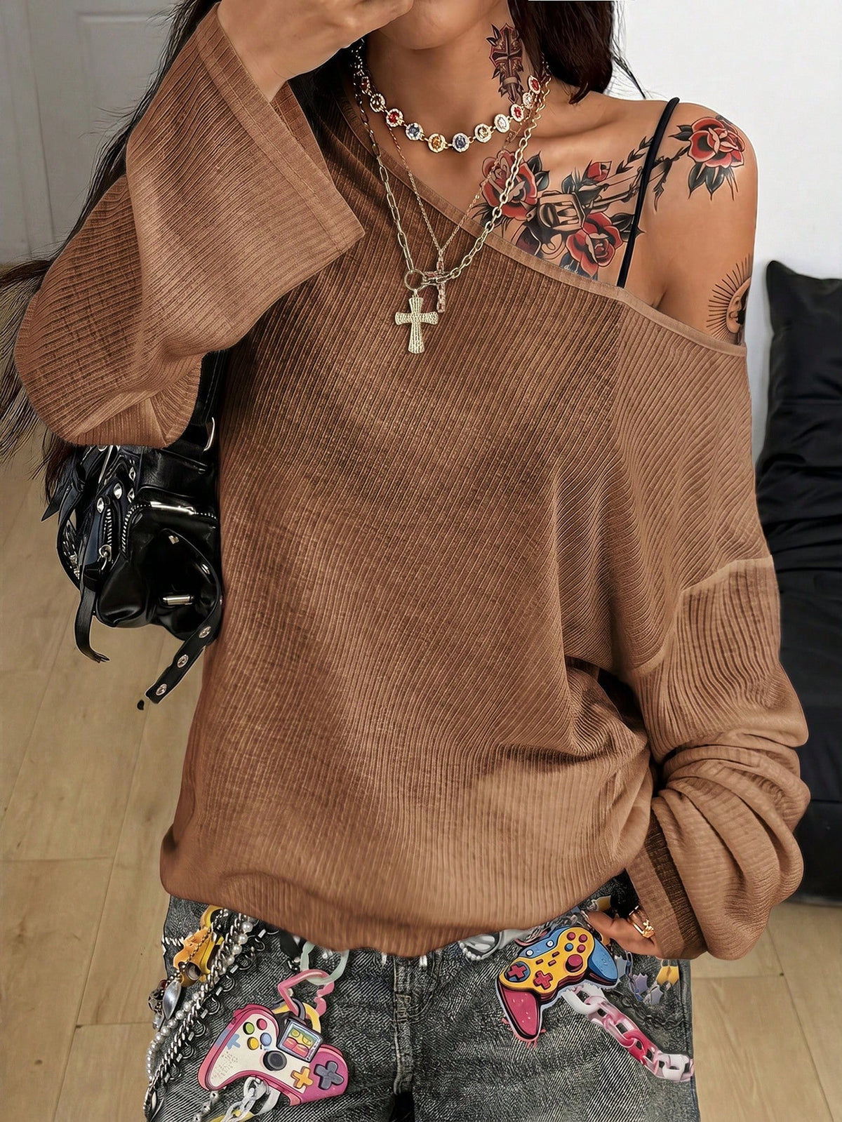 Women's off the shoulder long sleeve t-shirt featuring an asymmetrical neckline and loose fit in soft knitted fabric.