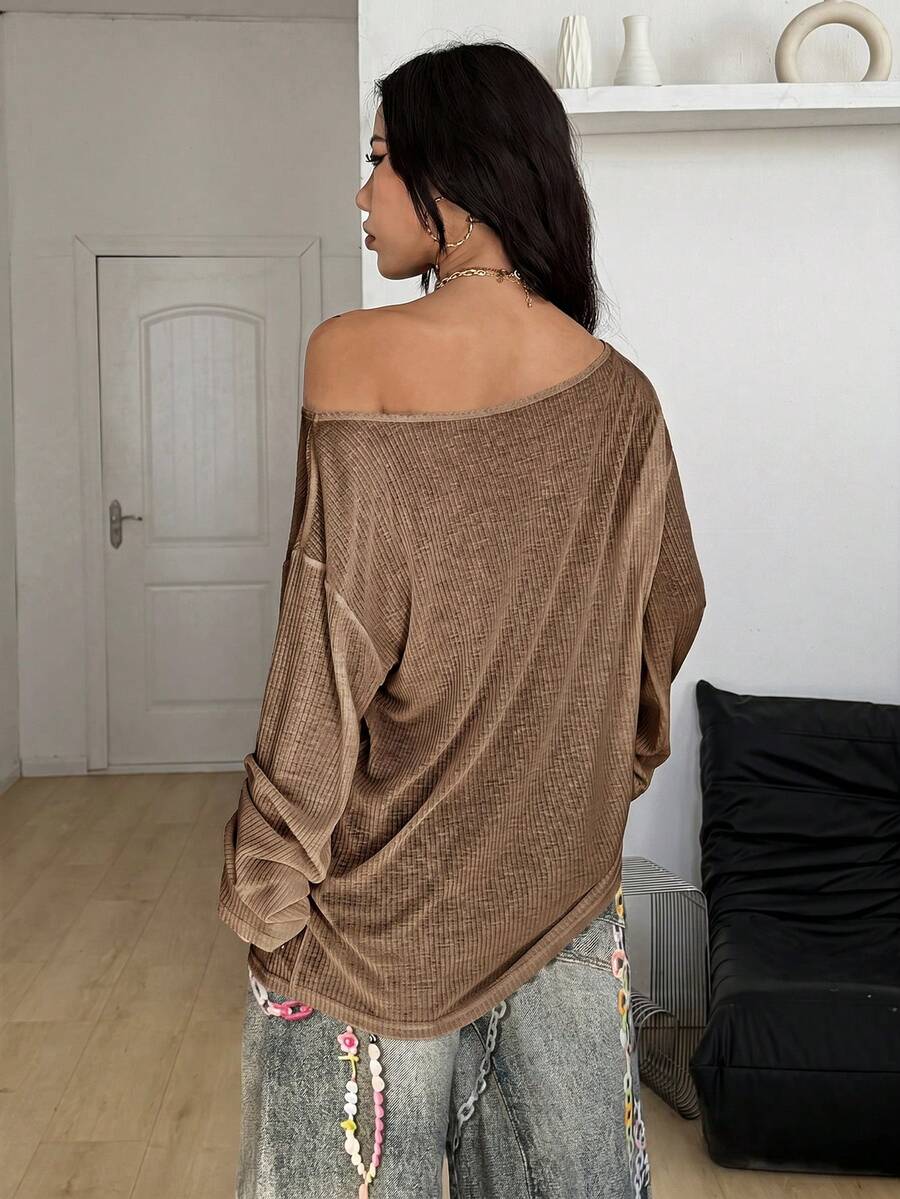 Women's off the shoulder long sleeve t-shirt featuring an asymmetrical neckline and loose fit in soft knitted fabric.
