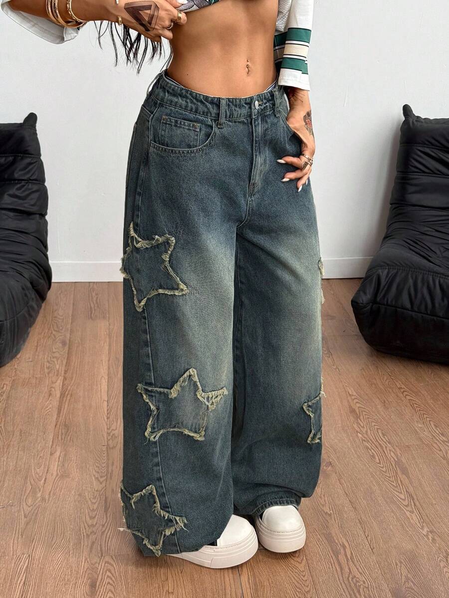 Women's loose fit baggy jeans in washed denim featuring star patches, slant pockets, and a mid-rise cut.