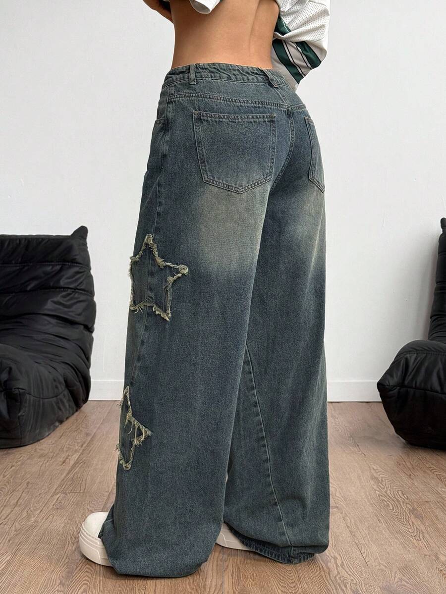 Women's loose fit baggy jeans in washed denim featuring star patches, slant pockets, and a mid-rise cut.