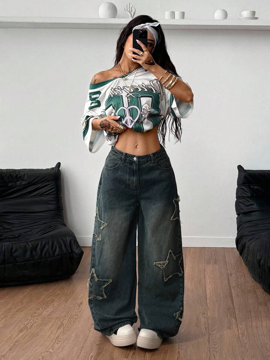 Women's loose fit baggy jeans in washed denim featuring star patches, slant pockets, and a mid-rise cut.