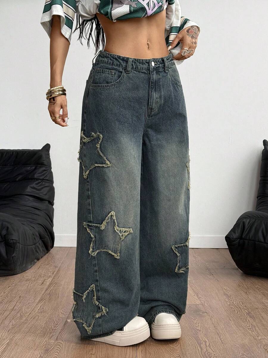Women's loose fit baggy jeans in washed denim featuring star patches, slant pockets, and a mid-rise cut.