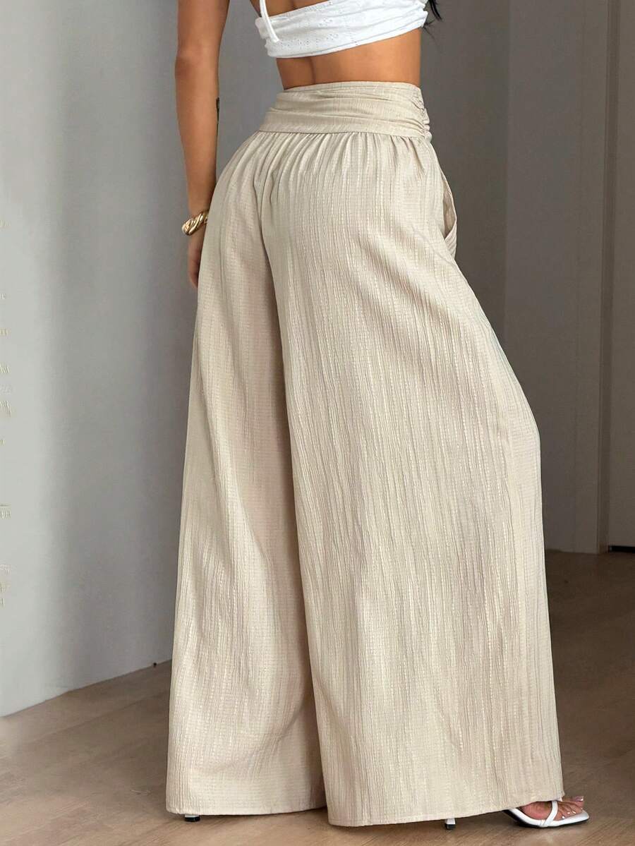 Women's plus size high-waist pleated wide leg pants in textured woven fabric with pockets