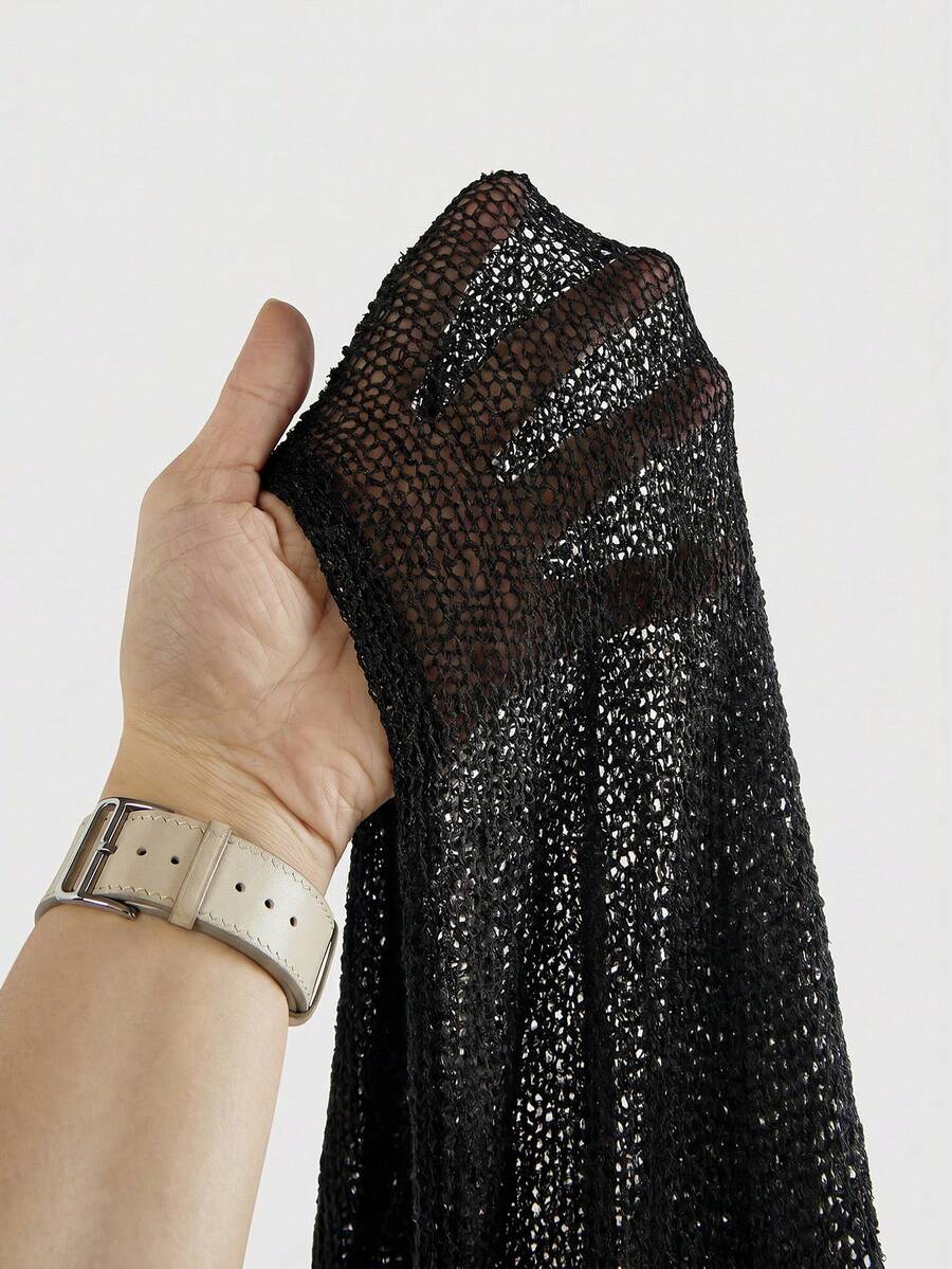 Women's casual hollow knit poncho top with boat neck, cloak sleeves, and asymmetrical hem