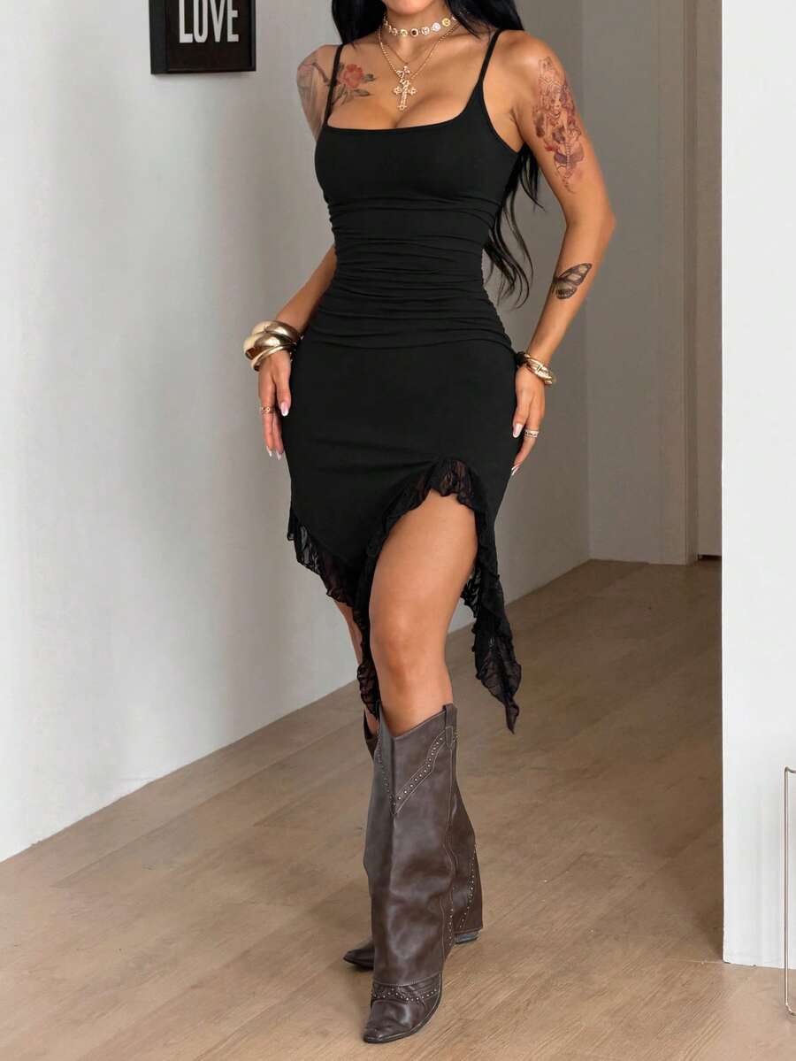 Front view of a women's black sleeveless bustier cami dress featuring spaghetti straps, a slim fit, and an asymmetrical split thigh hem.