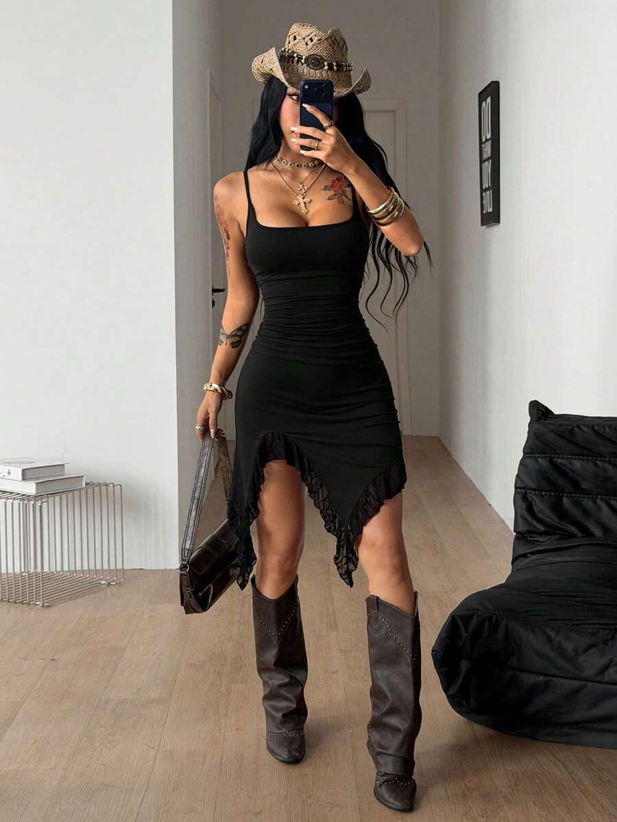 Front view of a women's black sleeveless bustier cami dress featuring spaghetti straps, a slim fit, and an asymmetrical split thigh hem.