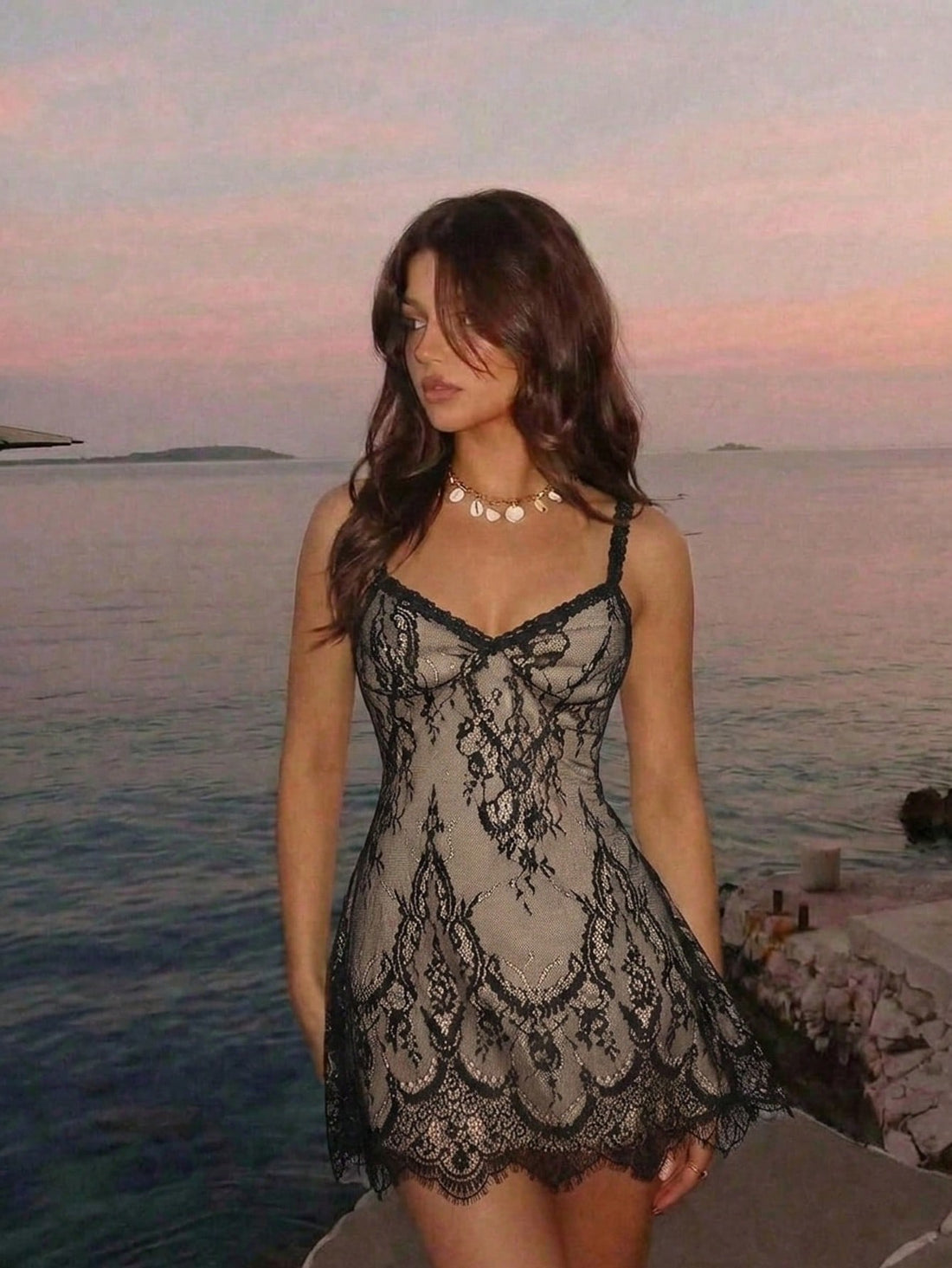 Women's short lace cami dress with spaghetti straps, contrast lace detailing, high waist, slim fit, and straight hem.