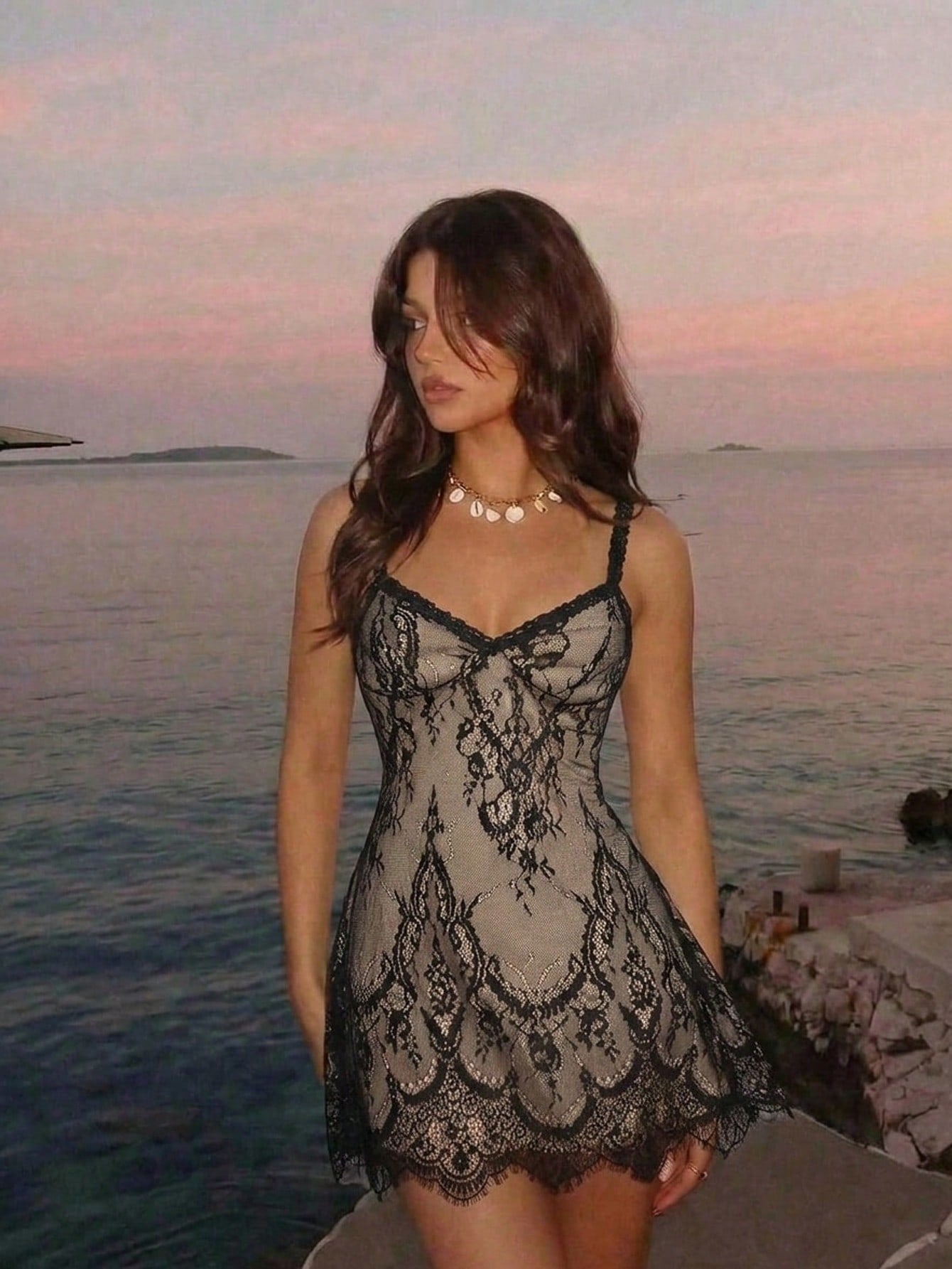 Women's short lace cami dress with spaghetti straps, contrast lace detailing, high waist, slim fit, and straight hem.