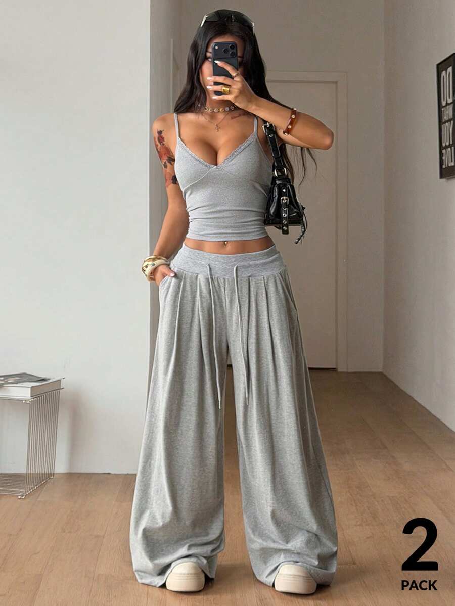 Women's two-piece grey loungewear set featuring a lace trim spaghetti strap camisole top with arm sleeves and wide-leg drawstring sweatpants.