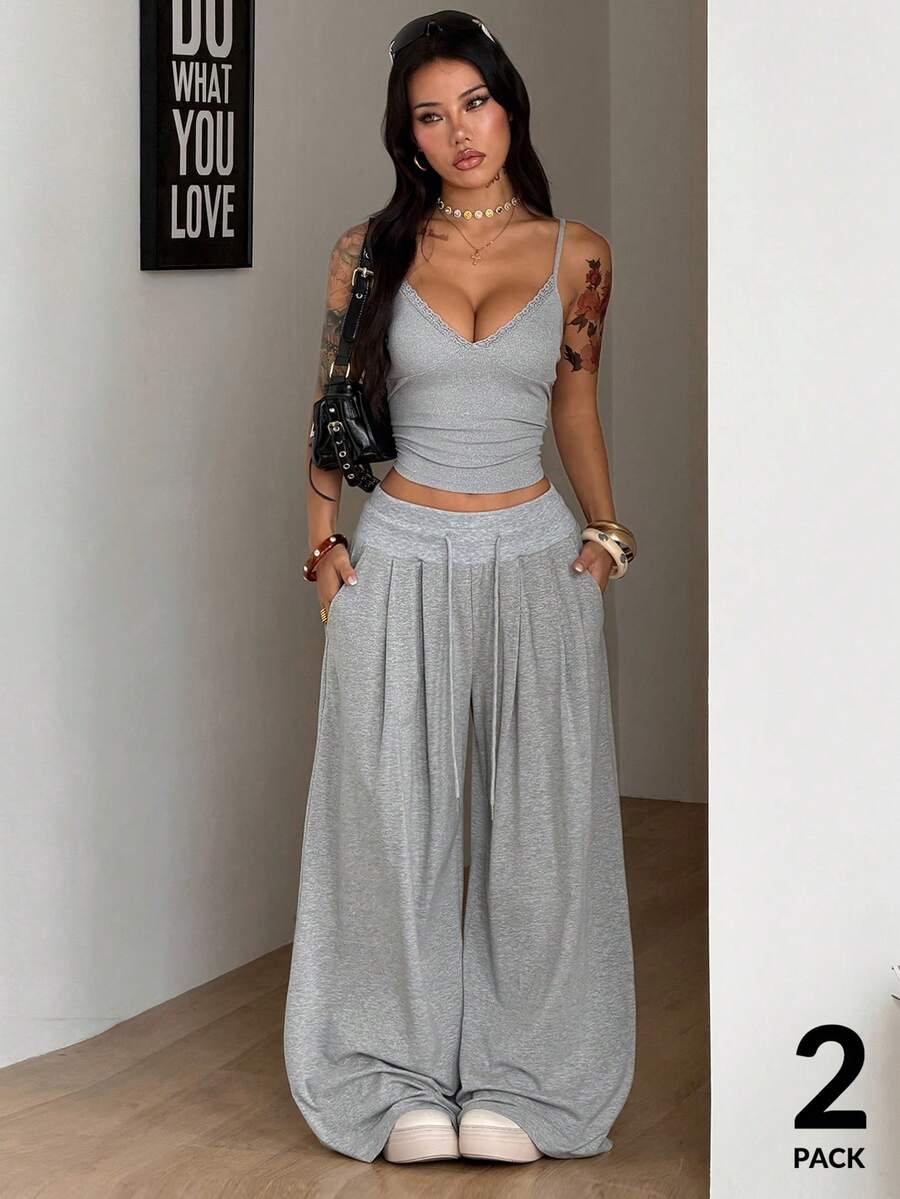 Women's two-piece grey loungewear set featuring a lace trim spaghetti strap camisole top with arm sleeves and wide-leg drawstring sweatpants.