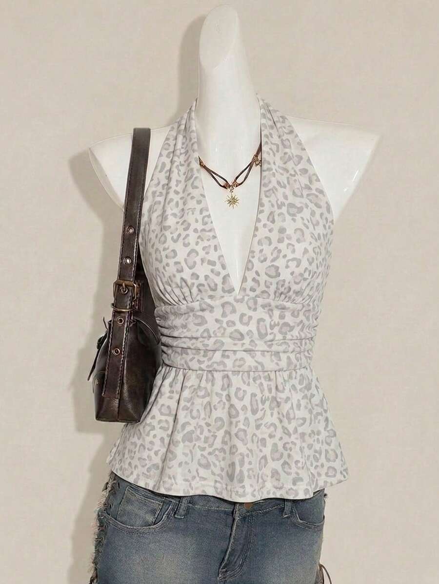 Women's backless halter babydoll tank top featuring a square neckline, slim fit silhouette, and a flared ruffle hem.