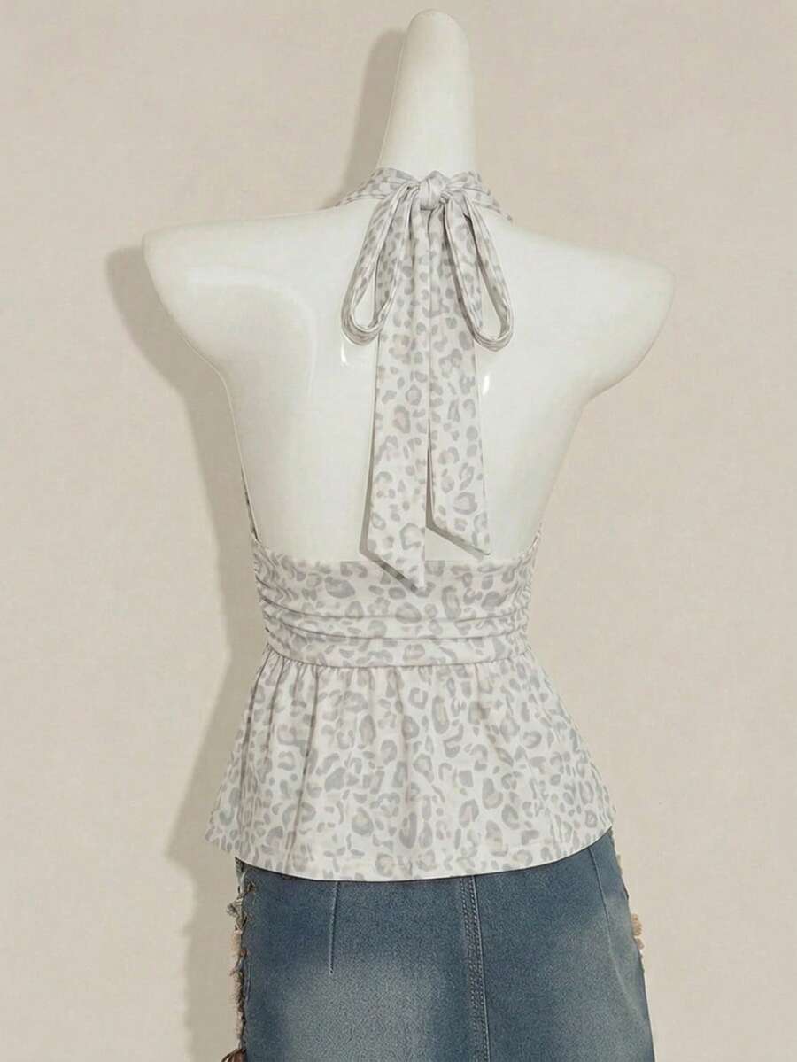 Women's backless halter babydoll tank top featuring a square neckline, slim fit silhouette, and a flared ruffle hem.