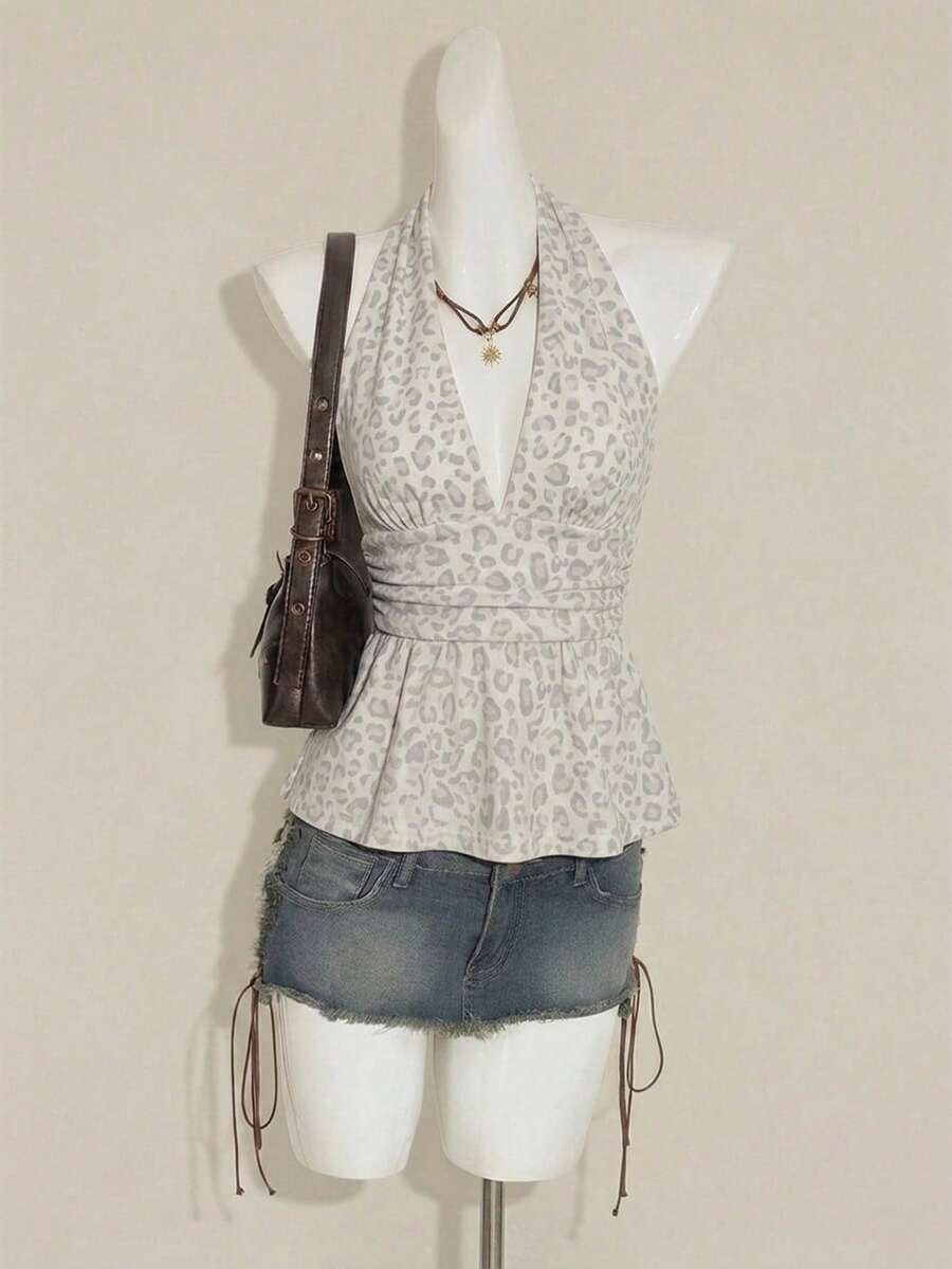 Women's backless halter babydoll tank top featuring a square neckline, slim fit silhouette, and a flared ruffle hem.