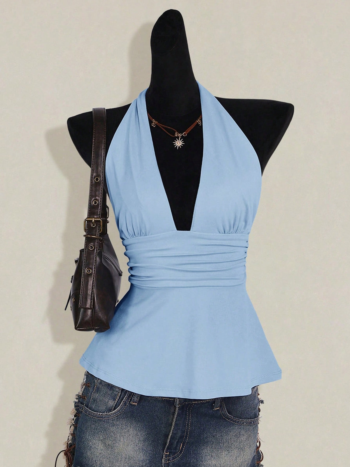 Women's backless halter babydoll tank top featuring a square neckline, slim fit silhouette, and a flared ruffle hem.