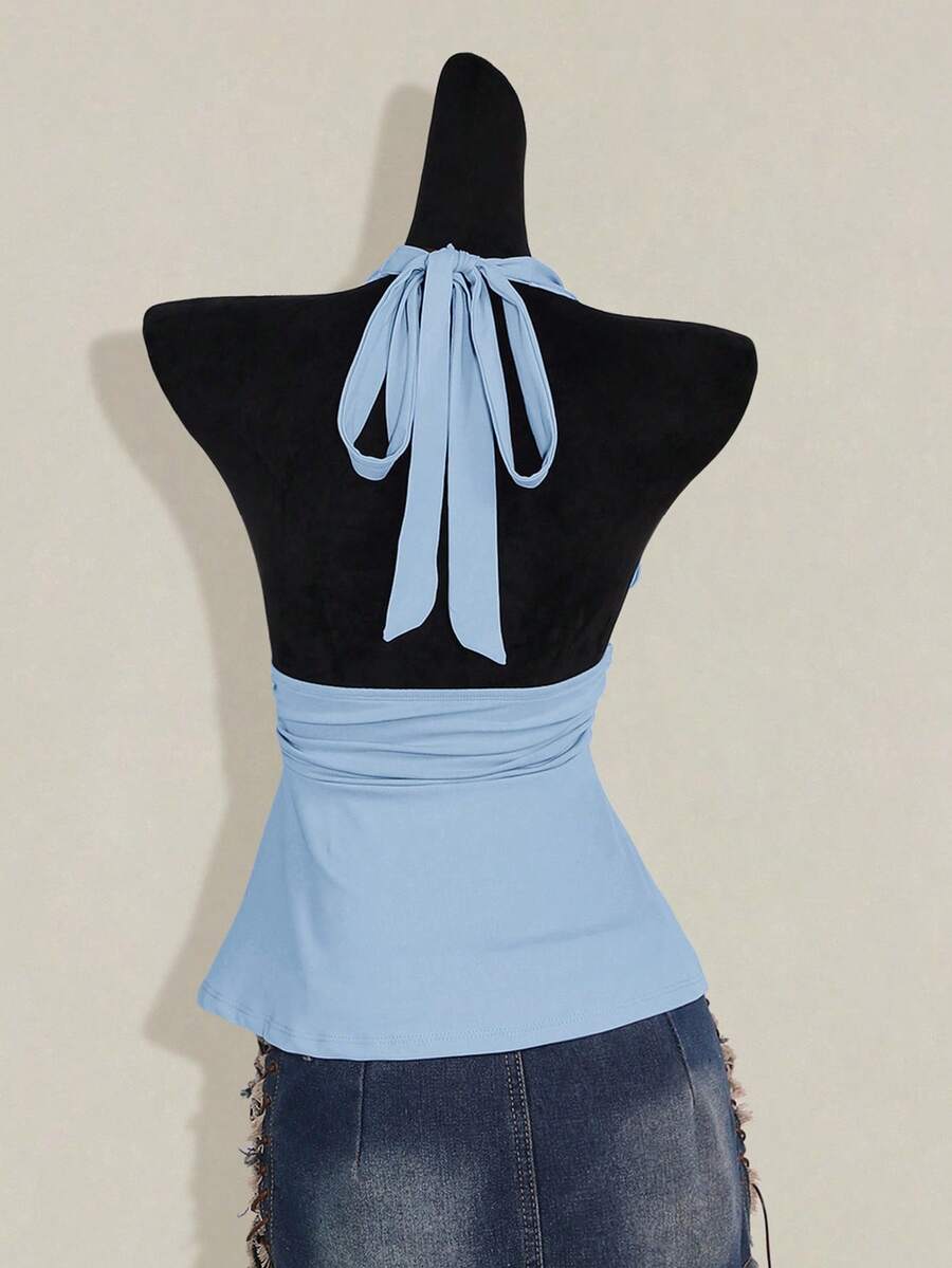 Women's backless halter babydoll tank top featuring a square neckline, slim fit silhouette, and a flared ruffle hem.