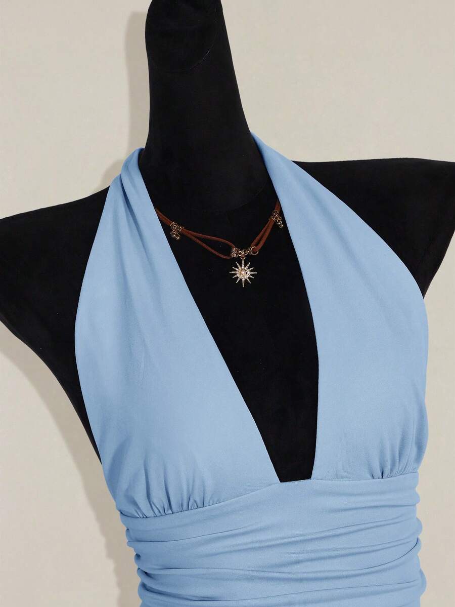 Women's backless halter babydoll tank top featuring a square neckline, slim fit silhouette, and a flared ruffle hem.