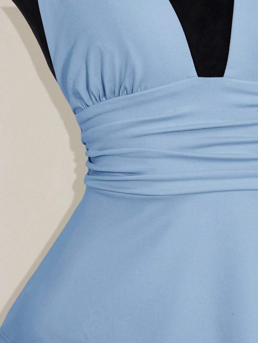Women's backless halter babydoll tank top featuring a square neckline, slim fit silhouette, and a flared ruffle hem.