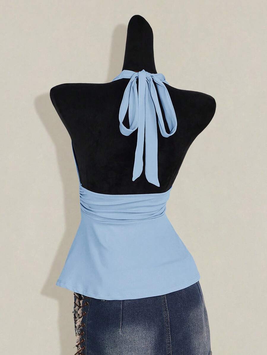 Women's backless halter babydoll tank top featuring a square neckline, slim fit silhouette, and a flared ruffle hem.