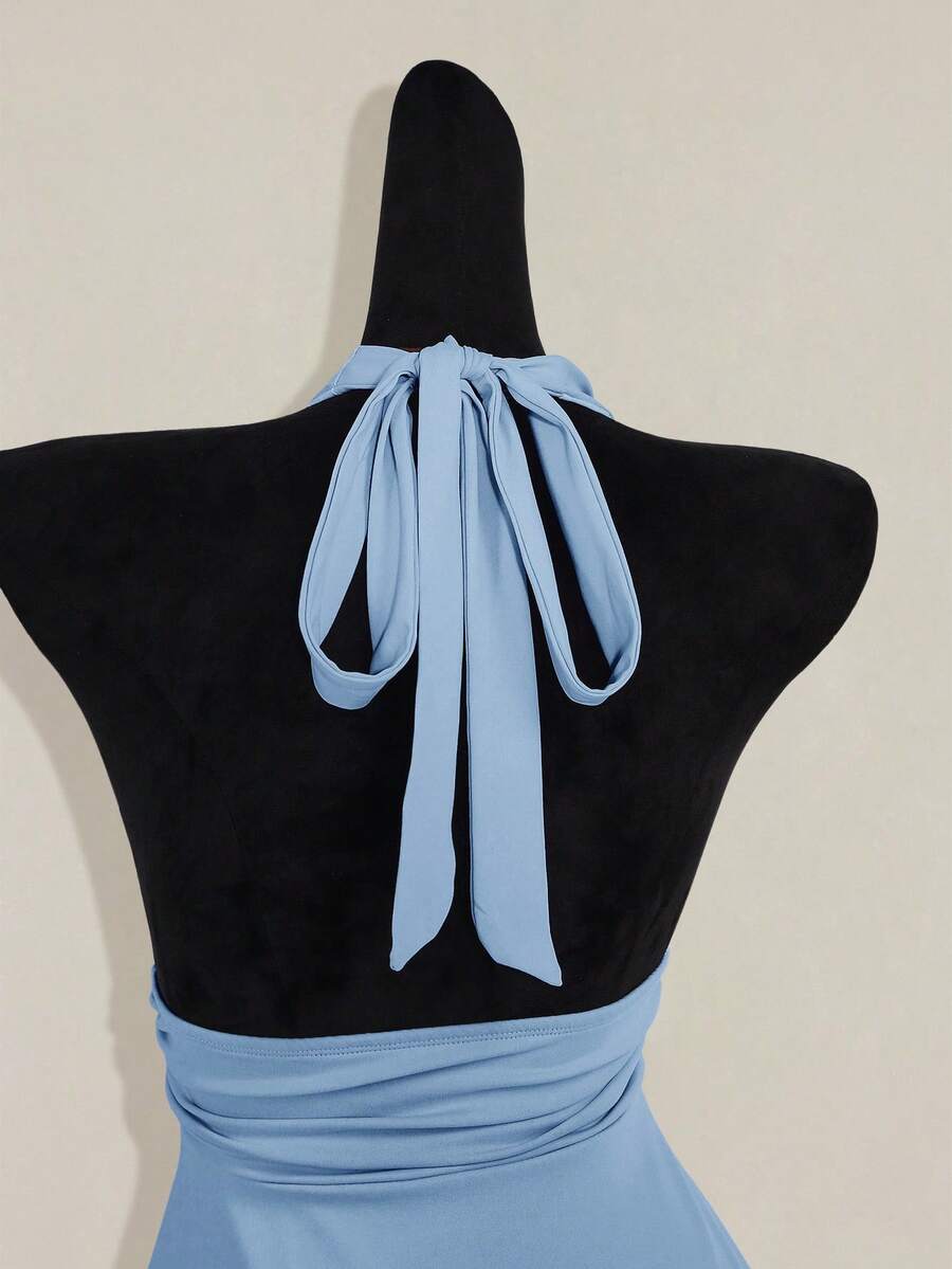 Women's backless halter babydoll tank top featuring a square neckline, slim fit silhouette, and a flared ruffle hem.