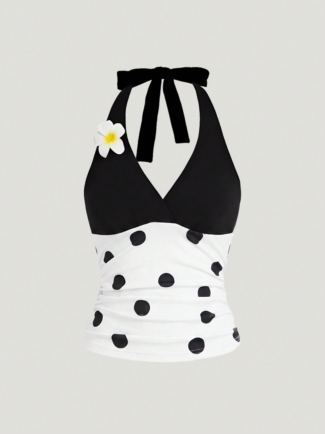 Women's black and white halter neck tank top with ladybug and daisy decor, geometric pattern, ruched front, knot detail, and backless design.