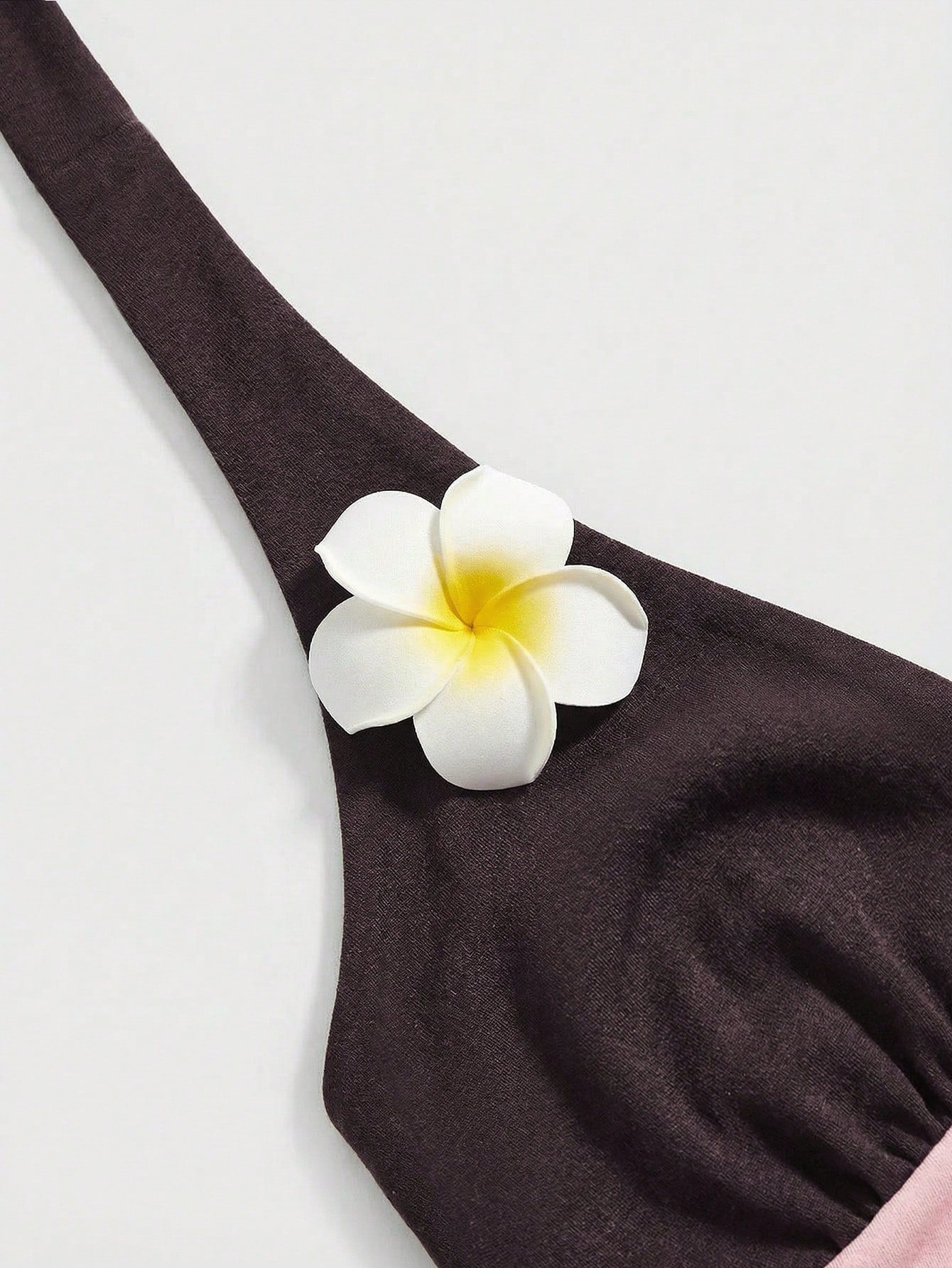 Women's black and white halter neck tank top with ladybug and daisy decor, geometric pattern, ruched front, knot detail, and backless design.