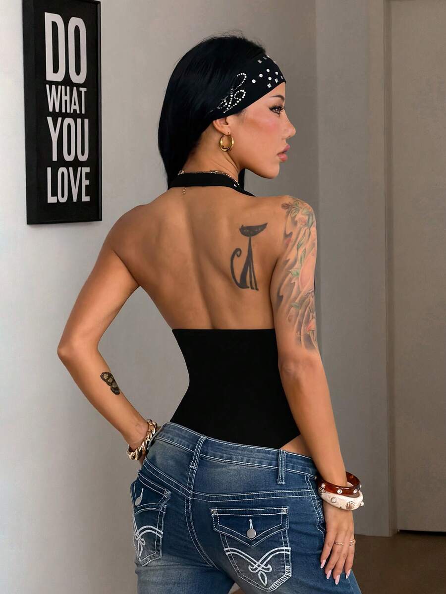 Women's black halter bodysuit featuring silver studded rivet details on a stretchy slim-fit sleeveless top.
