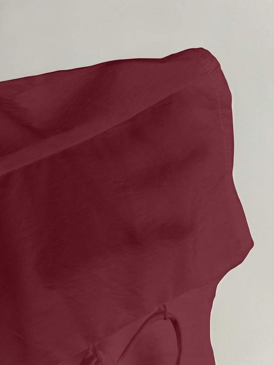 Women's black off-shoulder cap sleeve blouse with ruffled detailing and a tie-back design.