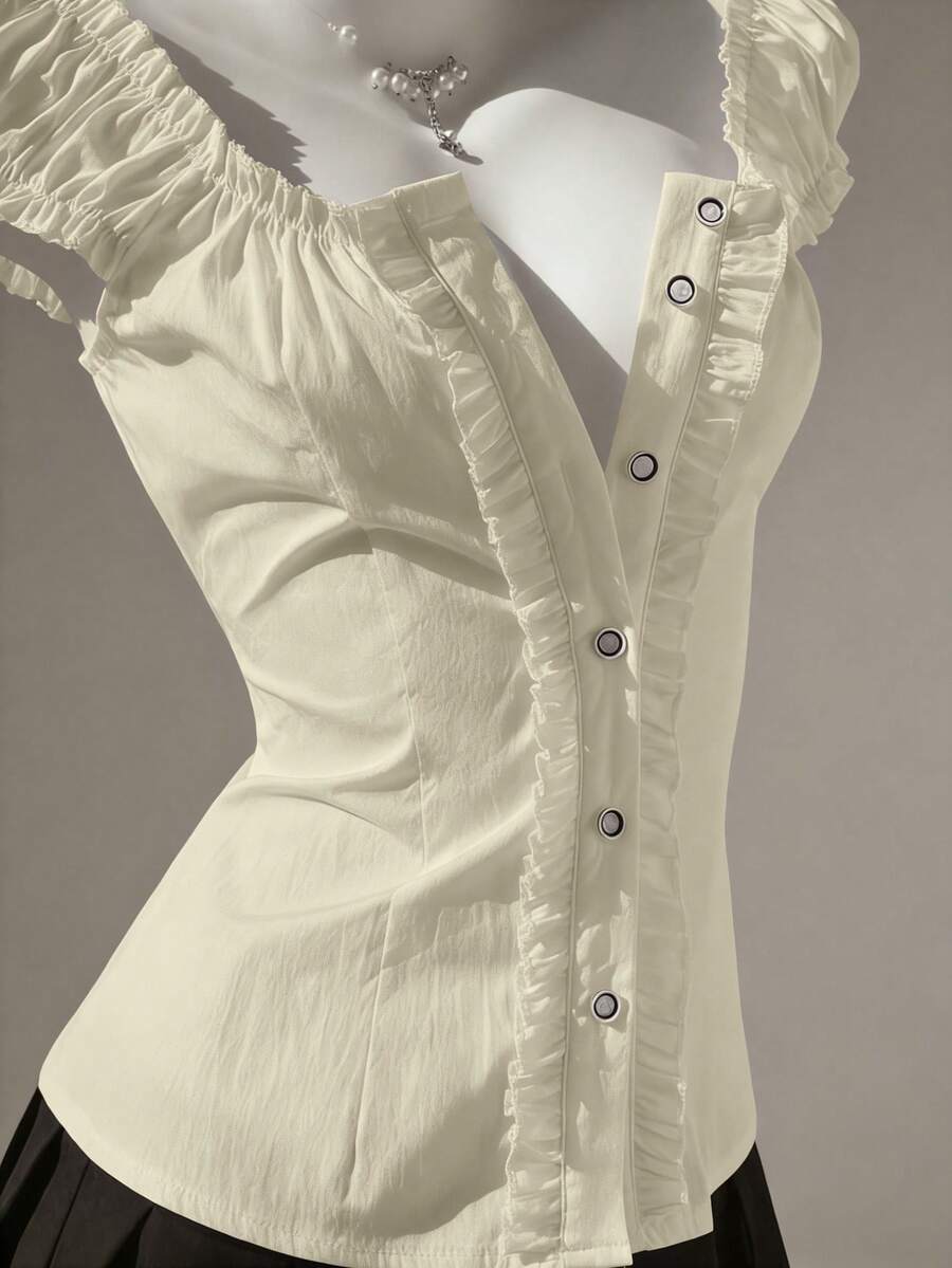 Women's black off-shoulder cap sleeve blouse with ruffled detailing and a tie-back design.