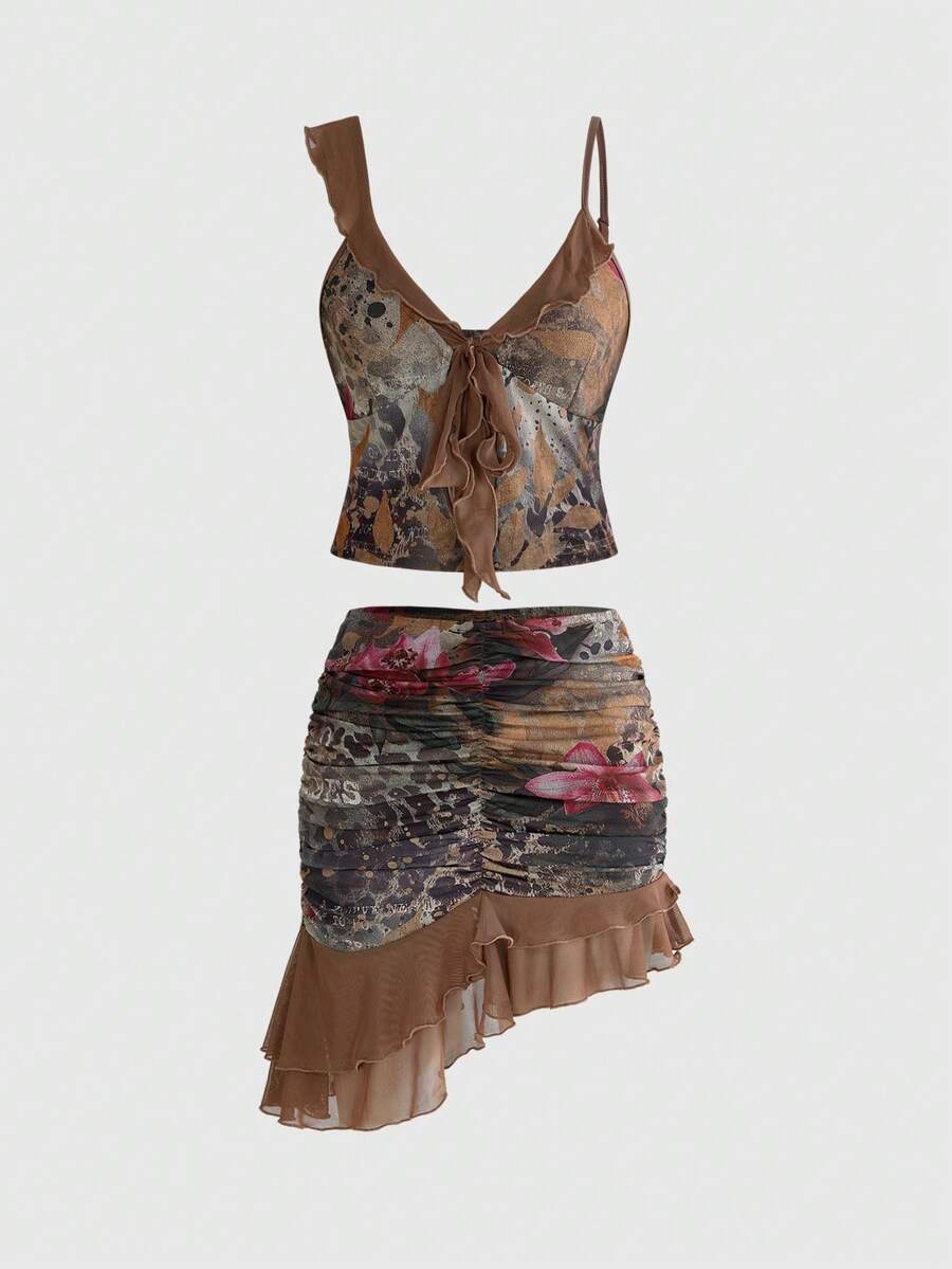 Women's brown two-piece set featuring a ruched camisole top with ruffle hem and asymmetrical neck alongside a plant print mini skirt.